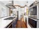 Open kitchen with stainless steel appliances, marble countertops, and hardwood floors at 1 Percy St, Charleston, SC 29403