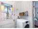 Laundry room with a stacked washer and dryer near a stained glass door at 1 Percy St, Charleston, SC 29403