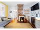 Inviting living room featuring a brick fireplace, hardwood floors, and stylish decor at 1 Percy St, Charleston, SC 29403