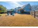 Beautiful backyard with a firepit, patio area, and lush landscaping at 101 Back Creek Ct, Summerville, SC 29485