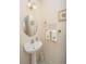 Bright powder room with pedestal sink, decorative mirror, and artwork at 101 Back Creek Ct, Summerville, SC 29485