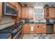 A modern kitchen with stainless steel appliances, dark countertops, and warm cabinets at 101 Back Creek Ct, Summerville, SC 29485