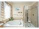 Luxurious main bathroom with a soaking tub and separate shower, perfect for relaxation at 101 Back Creek Ct, Summerville, SC 29485