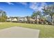 A backyard concrete patio with a lush green lawn, various styles of modern homes, and a black metal fence at 1028 Island Preserve Rd, Johns Island, SC 29455