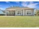 A spacious backyard featuring lush grass, a patio, and a screened in porch at 1028 Island Preserve Rd, Johns Island, SC 29455