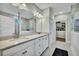 Bathroom with dual sinks, walk-in shower, and access to a spacious walk-in closet at 1028 Island Preserve Rd, Johns Island, SC 29455