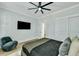 Cozy bedroom features a ceiling fan, large TV, and closet with sliding doors at 1028 Island Preserve Rd, Johns Island, SC 29455