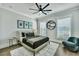 A stylish bedroom offers a ceiling fan, accent art, and a cozy armchair at 1028 Island Preserve Rd, Johns Island, SC 29455