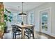 Bright dining room with a modern light fixture, a wood table, and natural light from a large window at 1028 Island Preserve Rd, Johns Island, SC 29455