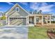 Charming home with a two-car garage, inviting front porch, and well-maintained landscaping at 1028 Island Preserve Rd, Johns Island, SC 29455