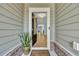 Inviting front entrance with a stylish door, potted plant, and 'Welcome Home' mat at 1028 Island Preserve Rd, Johns Island, SC 29455