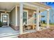 Inviting front porch with hanging plants, rocking chairs, and charming details, perfect for relaxing at 1028 Island Preserve Rd, Johns Island, SC 29455