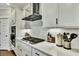 Well-lit kitchen featuring a modern gas range, stainless steel appliances, and sleek white cabinetry at 1028 Island Preserve Rd, Johns Island, SC 29455