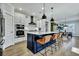 Modern kitchen features a large island with seating, pendant lighting, and stainless steel appliances at 1028 Island Preserve Rd, Johns Island, SC 29455