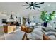 Sunlit living room with hardwood floors and a decorative ceiling fan adjacent to the island kitchen at 1028 Island Preserve Rd, Johns Island, SC 29455