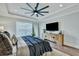 A main bedroom features a tray ceiling, modern ceiling fan, and a large TV at 1028 Island Preserve Rd, Johns Island, SC 29455