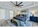 A stylishly decorated main bedroom with a bench, ceiling fan, and gray accents at 1028 Island Preserve Rd, Johns Island, SC 29455
