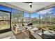 Outdoor screened porch featuring a comfortable seating area, fan, and backyard views at 1028 Island Preserve Rd, Johns Island, SC 29455