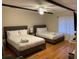 Bright bedroom with two beds, a ceiling fan, and hardwood floors, perfect for comfortable living at 104 Legend Oaks Way, Summerville, SC 29485