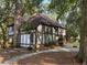 Charming Tudor-style home with a well-manicured front yard and mature trees at 104 Legend Oaks Way, Summerville, SC 29485