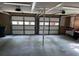 Spacious two car garage with two automatic doors, concrete floors, and overhead lighting at 104 Legend Oaks Way, Summerville, SC 29485