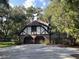 Home showcasing a two-car garage with beautiful brickwork, complemented by an extra-long driveway and manicured lawn at 104 Legend Oaks Way, Summerville, SC 29485