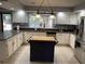Charming kitchen with white cabinets, stainless steel refrigerator and a convenient kitchen island at 104 Legend Oaks Way, Summerville, SC 29485