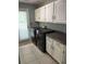 Functional laundry room featuring modern washer and dryer units and ample storage cabinets at 104 Legend Oaks Way, Summerville, SC 29485
