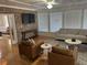 Cozy living room with hardwood floors, brick accent wall, and comfortable seating area at 104 Legend Oaks Way, Summerville, SC 29485