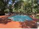Enjoy a refreshing pool surrounded by lush greenery and stylish furniture, creating an ideal outdoor retreat at 104 Legend Oaks Way, Summerville, SC 29485