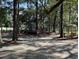 Wooden deck with a charming pergola amidst the mature tree-filled lawn adding to the beauty of the property at 104 Legend Oaks Way, Summerville, SC 29485