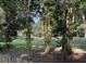 Overlook the expansive and lush green yard, an idyllic natural setting, surrounded by mature trees at 104 Legend Oaks Way, Summerville, SC 29485