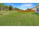 Lush backyard featuring a large grass area and a wooden fence separating the property from the forest at 104 Mayfield Dr, Goose Creek, SC 29445