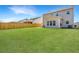 Spacious backyard featuring lush green grass, a wooden fence, and the home's rear exterior at 104 Mayfield Dr, Goose Creek, SC 29445