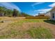 Large fenced backyard with a mix of greenery and dormant grass, bordered by trees and the home's exterior at 104 Mayfield Dr, Goose Creek, SC 29445