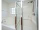 Well-lit bathroom showcasing a separate tub and tiled shower with glass door at 104 Mayfield Dr, Goose Creek, SC 29445