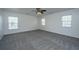 Spacious bedroom features plush carpeting, ceiling fan, and three bright windows at 104 Mayfield Dr, Goose Creek, SC 29445