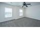 Bedroom features plush carpeting, ceiling fan, and two bright windows at 104 Mayfield Dr, Goose Creek, SC 29445