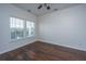Bright bedroom with hardwood floors, a ceiling fan, and two windows that let in natural light at 104 Mayfield Dr, Goose Creek, SC 29445
