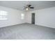 Large carpeted bedroom with a ceiling fan, and two windows for natural light at 104 Mayfield Dr, Goose Creek, SC 29445