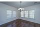 Dining area featuring hardwood floors, modern chandelier, and bright, sunlit windows at 104 Mayfield Dr, Goose Creek, SC 29445