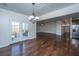 Open-concept dining area featuring hardwood floors and access to kitchen and outdoor patio at 104 Mayfield Dr, Goose Creek, SC 29445