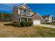 Two-story home featuring a brick facade, attached two-car garage, and well-maintained lawn on a sunny day at 104 Mayfield Dr, Goose Creek, SC 29445