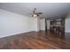 Open-concept living room with hardwood floors, ceiling fan, and an open layout, seamlessly connecting to the kitchen at 104 Mayfield Dr, Goose Creek, SC 29445