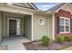 Welcoming entryway with a black front door, sidelight window and manicured shrubs at 109 Charlesfort Way, Moncks Corner, SC 29461