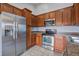 This kitchen boasts stainless steel appliances, wood cabinets and tile flooring at 109 Charlesfort Way, Moncks Corner, SC 29461