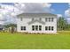 Expansive backyard with neat landscaping, a freshly cut lawn, and a pristine white exterior at 110 Crosscut Ln, Summerville, SC 29486