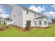 Spacious backyard features lush grass, clean white siding, and well-manicured landscaping at 110 Crosscut Ln, Summerville, SC 29486