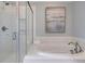 Bright bathroom features a soaking tub, walk-in shower, and white subway tile at 110 Crosscut Ln, Summerville, SC 29486