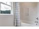 Relaxing bathroom showcases a tub with stylish tile and a window overlooking a lush view at 110 Crosscut Ln, Summerville, SC 29486